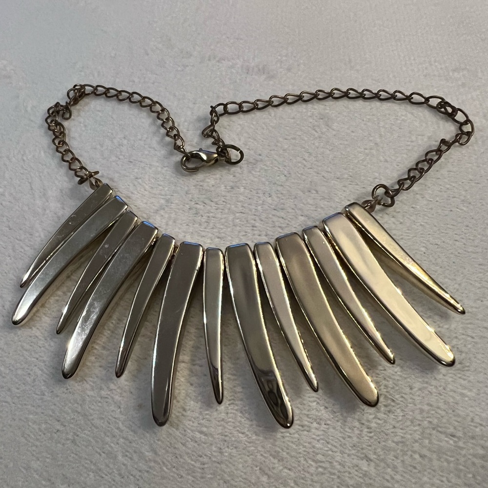 Plastic very light statement piece. Easy on the neck